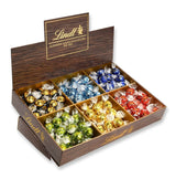 Présentation du dessus de chocolat Lindor | 1718 g and chocolate bars with marzipan | 25 barres x 50g en présentoir | 1250g | Pâte d'amande pure recouverte de chocolat noir | Barres de chocolat