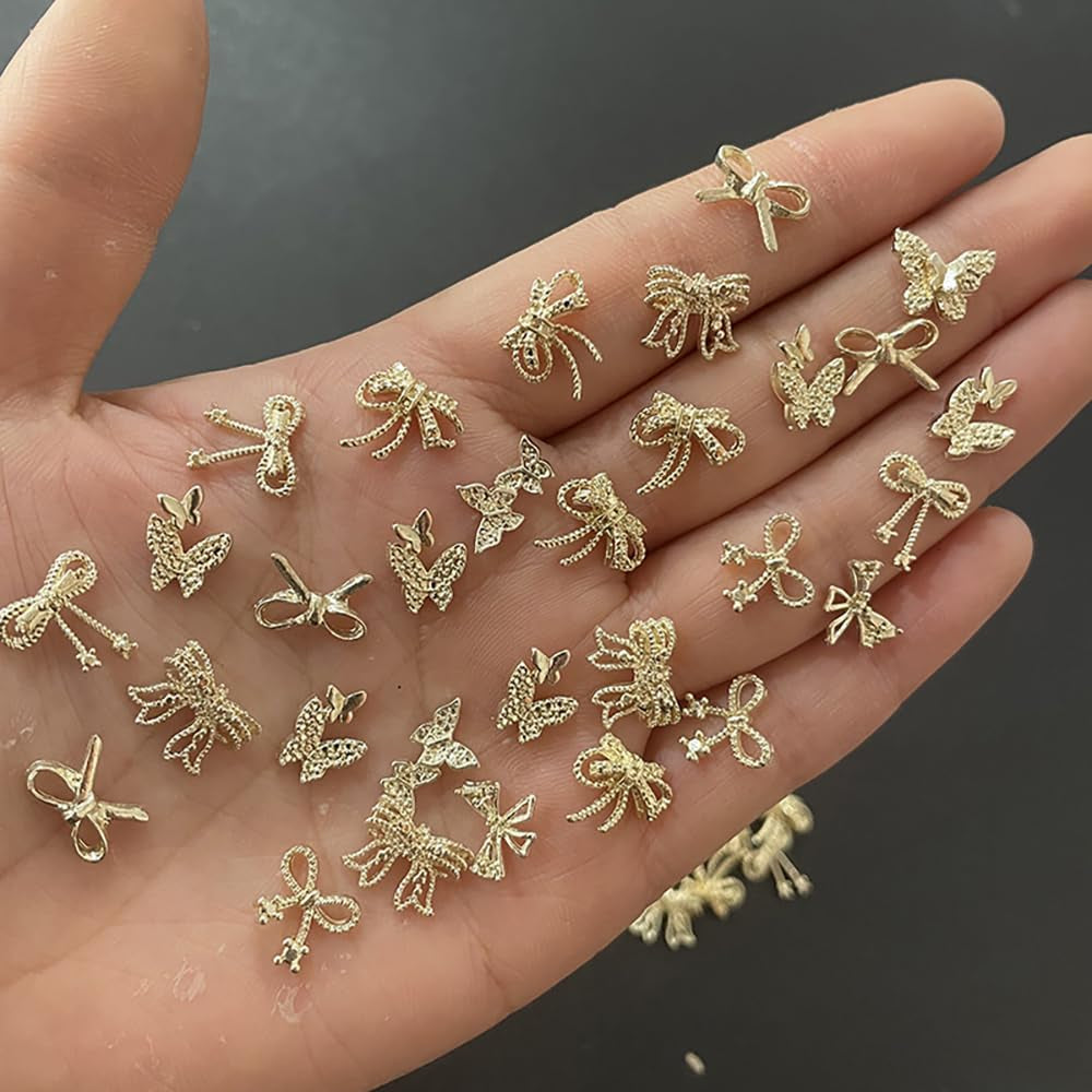 50pcs 3D Gold Bow Nail Charms Butterfly Nail Art Charms Legierung Bogen Nagel Charms Nägel Zubehör Schleife Nagelschmuck Metall Schleifen Schmetterling Nageldesign Nagelanhänger Nailart Strasssteine